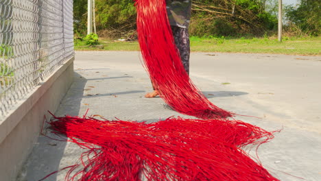 Laying-red-colored-straws-in-the-sun-before-weaving-them-in-the-carpet-or-mattress