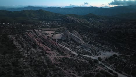 Famous-Vasquez-Rocks-in-Sierra-Pelona-Mountains,-film-site-and-Nature-area,-aerial-drone-flyover-during-blue-hour