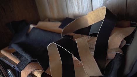 Leather-scraps-lying-around-leatherworker-workshop