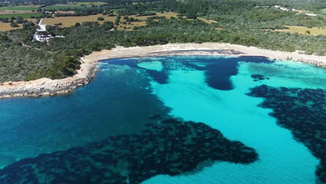 Dron-Cinemático-Sale-De-La-Playa-De-Arena-Blanca-De-Menorca-Para-Revelar-Un-Enorme-Sistema-De-Arrecifes