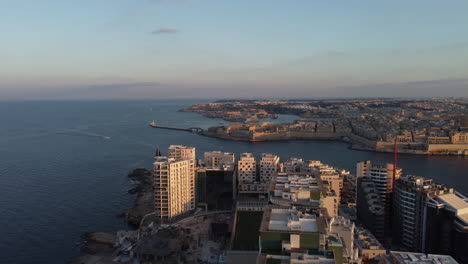 Sun-rise-Drone-footage-of-Valletta-harbor-in-the-morning,-Malta