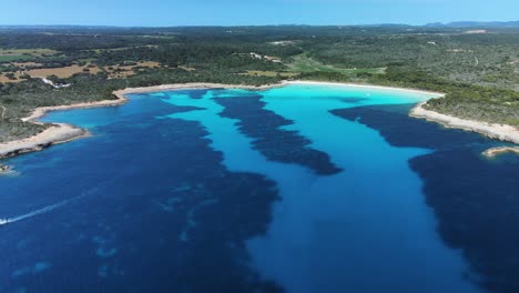 Cinematic-drone-flight-into-hidden-coastal-bay-in-Menorca,-Europeans-best-kept-secret