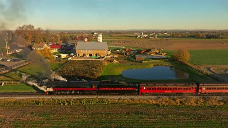 Drone-Parallel-View-of-a-Steam-Engine-Blowing-Lots-of-Smoke-and-Backing-Up-in-the-Early-Morning-Traveling-Thru-the-Farmlands