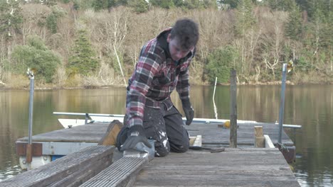 Young-male-planking-wooden-jetty