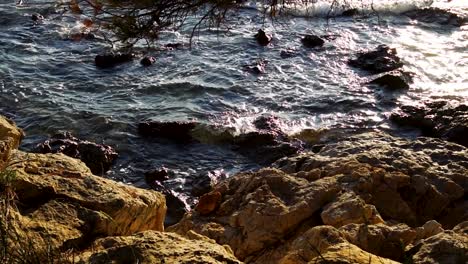 Waves-crashing-on-the-beach-shore-during-golden-hour,-Murter-Croatia