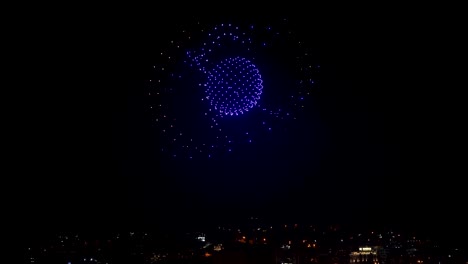 Drone-show-displaying-geometric-models-on-the-night-sky-over-the-city,-image-composition-by-new-technology