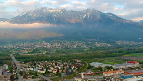 Scenic-View-Over-Swiss-Town-With-Mountains-In-Background-In-Switzerland---aerial-drone-shot