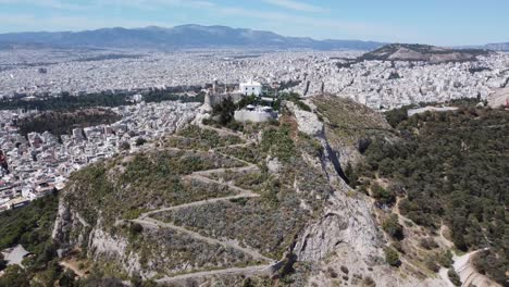 Rising-drone-video-of-Mount-Lycabettus,-in-Athens,-Greece