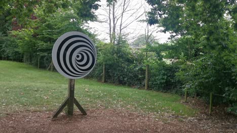 A-Spinning-Spiral-Optical-Illusion-on-a-Wooden-Pole-in-a-Park