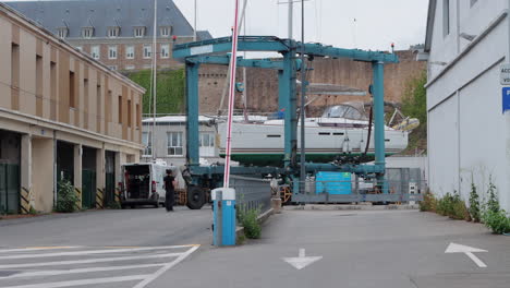 Large-yacht-in-dry-dock-being-moved-to-different-location-in-Brest,-France