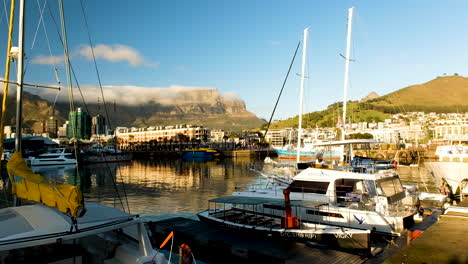 Boats-anchored-at-marina,-Table-Bay-harbor-marina,-Table-Mountain-backdrop