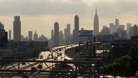 Manhattan,-New-York-City,-Skyline-Silhouetted-In-Late-Afternoon-Sun-With-Highway-In-Foreground