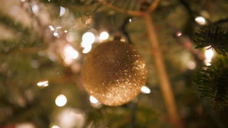sparkly-golden-ornament-hanging-from-Christmas-tree