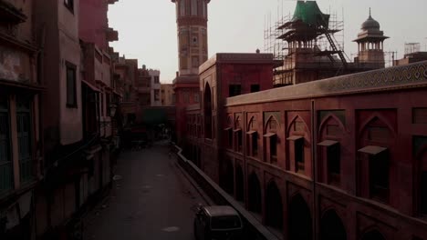 Aerial-Dolly-Beside-Wall-Of-Wazir-Khan-Mosque-Towards-Minaret-In-Lahore