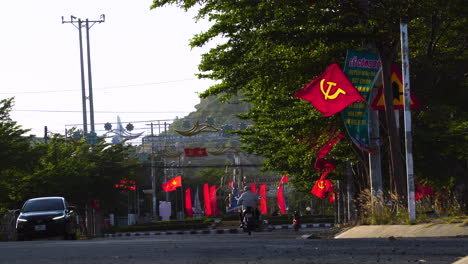 Street-view-of-Vietnam-city-with-country-flags-and-Hammer-and-Sickle-flag