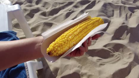 Holding-Sweet-Corn-on-the-Beach