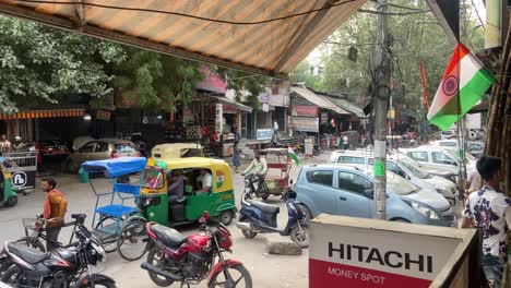 A-static-shot-of-chaotic-traffic-in-old-Delhi-road-where-few-cars-and-bikes-are-seen-parked-alongside-of-the-road