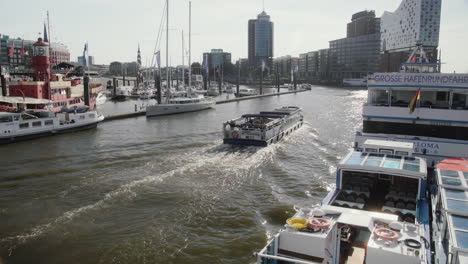 Tourist-Boat-Passing-By-At-Hamburg-Landungsbrücken-With-Elbphilharmonie
