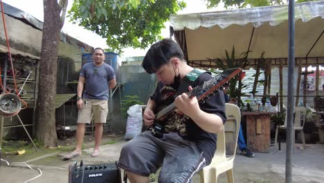 A-dynamic-footage-of-a-bass-guitarist-while-testing-the-tuning-of-his-guitar