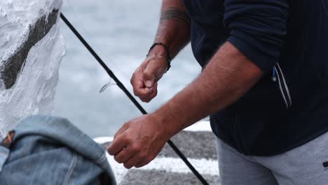 Man-Tying-A-Fishing-Hook,-Fishing-Line---close-up