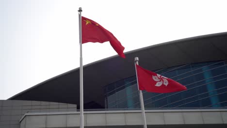 Chinese-And-Hong-Kong-National-Flags-Fluttering-In-Wind-At-Golden-Bauhinia-Square