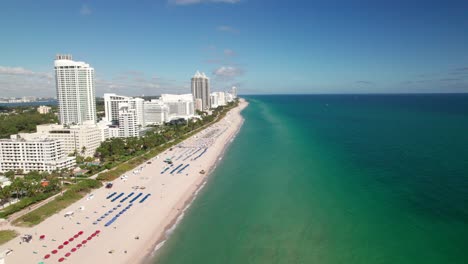 Caribbean-Beachfront-drone-shot.-Hotels,-resorts,-umbrellas