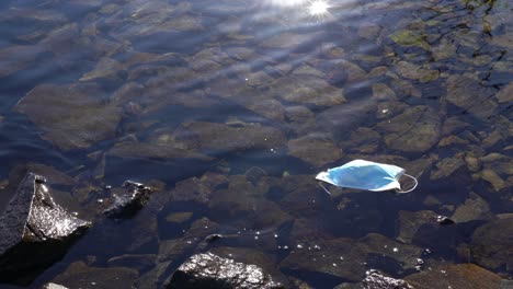 Discarded-face-mask-used-during-Covid-19-pandemic-floating-in-Norway-fjord