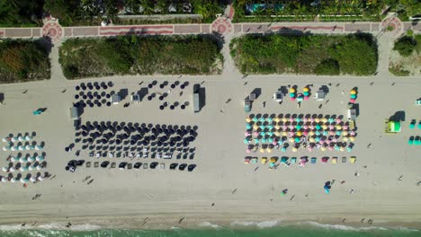 Overhead-drone-shot-of-colorful-umbrellas-along-the-beach