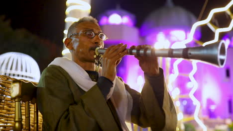 An-old-oriental-man-playing-the-oboe-at-an-oriental-Egyptian-wedding-ceremony--medium-shot