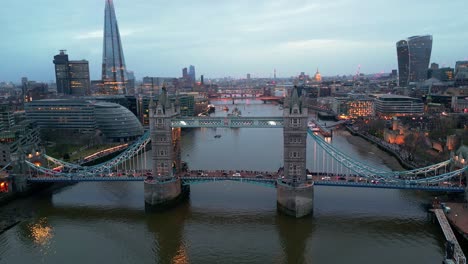 Truck-left-pedestal-down-drone-shot-of-the-Tower-Bridge-in-London,-England,-during-the-evening