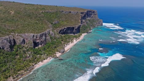Massive-rock-formation,-half-island,-tropical-caribbean,-wave-crash,-aerial-view