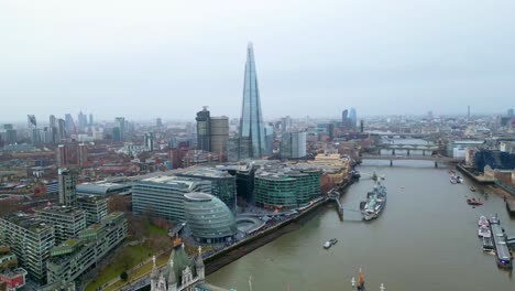 Orbital-right-to-left-drone-shot-of-the-Shard-and-the-City-Hall-of-London,-England