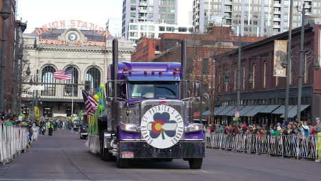 Large-semi-truck-driving-in-the-Saint-Patrick's-Day-Parade-in-Denver,-Colorado