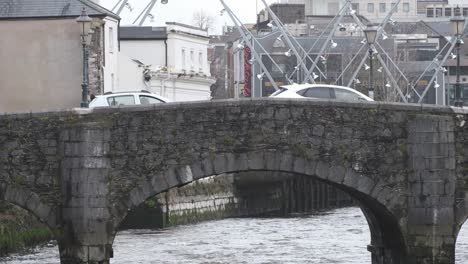 Close-up-South-Gate-stone-bridge-Cork-City-on-overcast-day-with-river-Lee-flowing