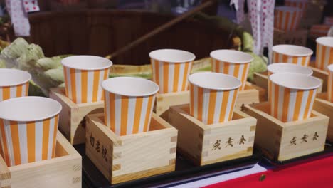 Free-Festival-Sake-Cups-at-Honensai-Fertility-Festival-in-Komaki,-Aichi-Japan