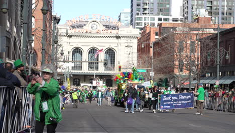Crowds-of-people-walking-through-the-streets-celebrating-Saint-Patrick's-Day-in-downtown-Denver,-Colorado