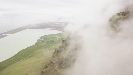 a-drone-shot-of-revealing-a-landscape-from-the-clouds