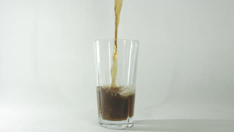 slow-motion-footage-of-cola-being-poured-into-a-glass-against-a-clear-light-background