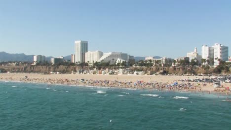 A-beautiful-off-shore-shot-of-the-famous-Santa-Monica-Beach-with-many-beach-goers-enjoying-the-summer