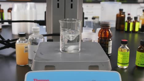 Establishing-shot-of-machine-in-a-science-lab-testing-chemicals-in-a-clear-glass-bottle