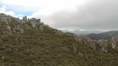 Man-standing-on-a-mountain-ridge