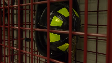 Firefighter-helmet-hangs-in-a-locker-at-a-fire-station