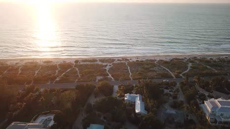 Aerial-drone-shot-of-villas-overlooking-the-beach-on-Captiva-Island,-Florida,-at-sunset