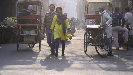 Couple-Waling-on-busy-street-in-the-city-at-misty-winter-morning-Delhi-Chandni-Chowk-India