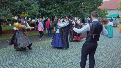 Folklore-dancers-performing-on-street-with-accordeon-player