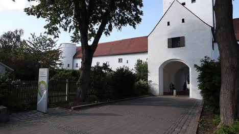 Ingolstadt,-lower-part-of-Taschenturm-with-people-passing-by,-Bavaria,-Germany