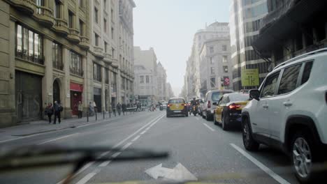 Driving-in-Barcelona-city-center-traffic-on-a-sunny-day-during-summer