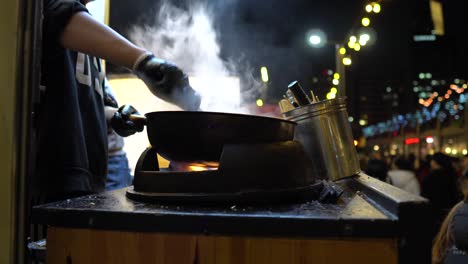 Chef-toss-up-cooking-food-on-a-big-frying-pan