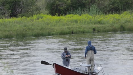 Two-men-fishing-in-small-boat-on-Snake-River,-Idaho