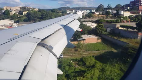 View-from-inside-a-plane-while-landing-at-an-airport-in-the-middle-of-a-densely-populated-city